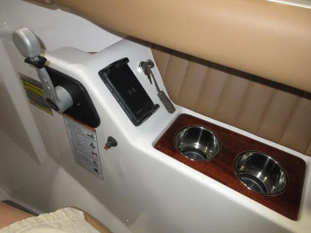 Slide: The Image of Control panel of 2023 Thoroughbred u23i boat with cup holders and key slot. - 17