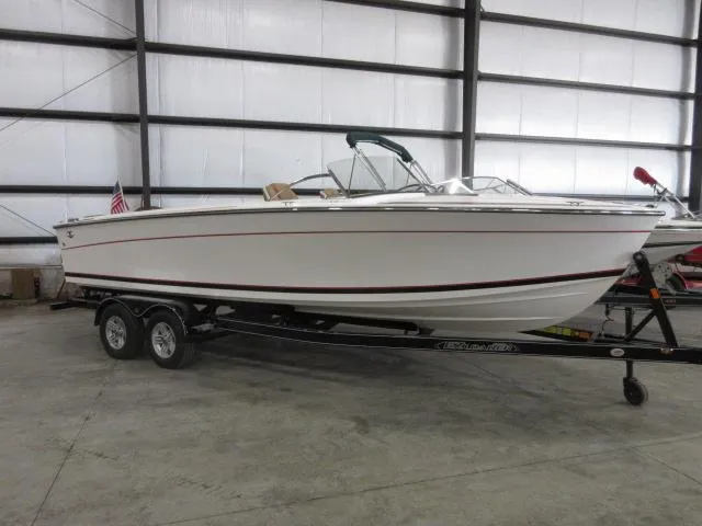 Slide: The Image of 2023 Thoroughbred u23i boat on trailer in indoor storage. - 2