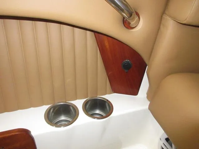 Slide: The Image of Interior of 2023 Thoroughbred u23i boat with cup holders and tan upholstery. - 34