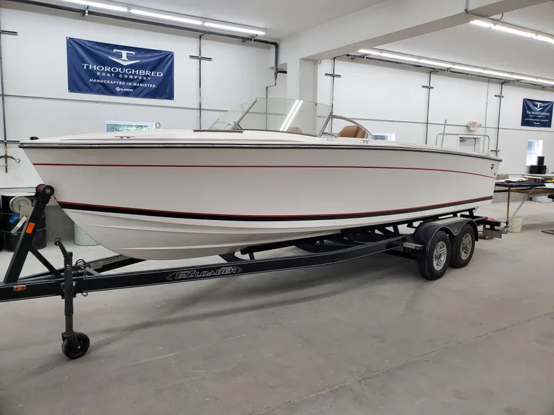 Slide: The Image of 2023 Thoroughbred u23i boat on a trailer in a showroom. - 36