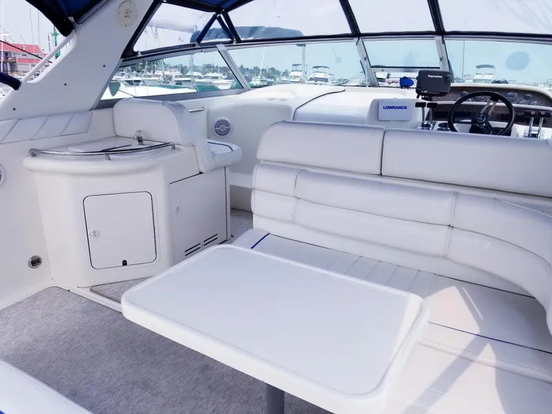 Slide: The Image of 1996 Sea Ray 330 Sundancer interior with white seating and table. - 18