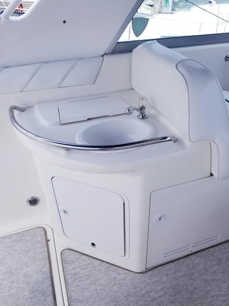 Slide: The Image of 1996 Sea Ray 330 Sundancer boat interior sink and storage area. - 23