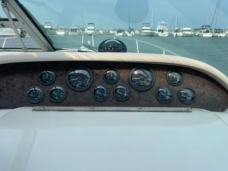 Slide: The Image of Dashboard of a 1996 Sea Ray 330 Sundancer boat with gauges and marina view. - 29