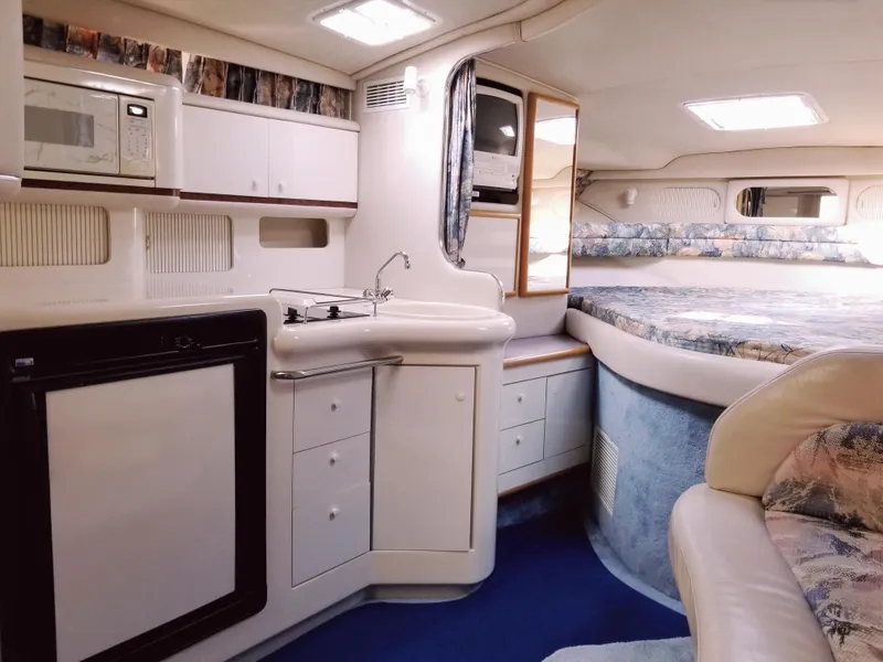 Slide: The Image of Interior of 1996 Sea Ray 330 Sundancer with kitchenette and sleeping area. - 38