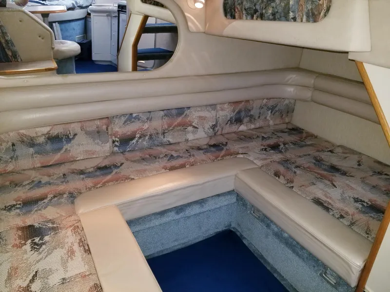 Slide: The Image of 1996 Sea Ray 330 Sundancer interior cabin with patterned seating and storage. - 47