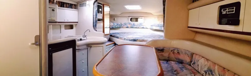 Slide: The Image of Interior of 1996 Sea Ray 330 Sundancer yacht with kitchenette, dining area, and sleeping quarters. - 48