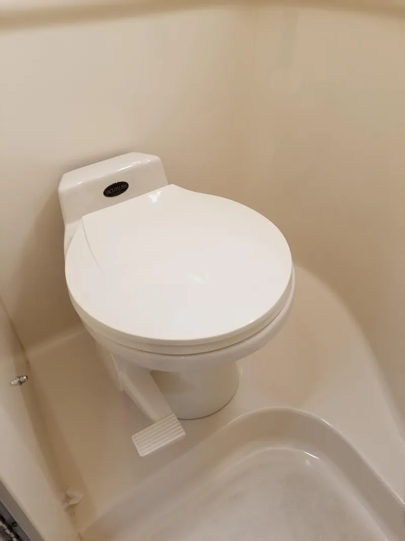 Slide: The Image of 1996 Sea Ray 330 Sundancer marine toilet in clean condition. - 49