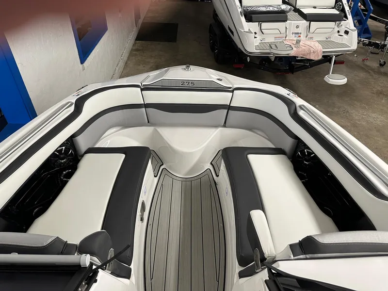 Slide: The Image of Interior view of 2023 Yamaha Boats 275SD with gray and white seating. - 2
