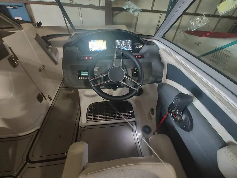 Slide: The Image of 2022 Cobalt 23SC boat cockpit with steering wheel and control panel. - 16