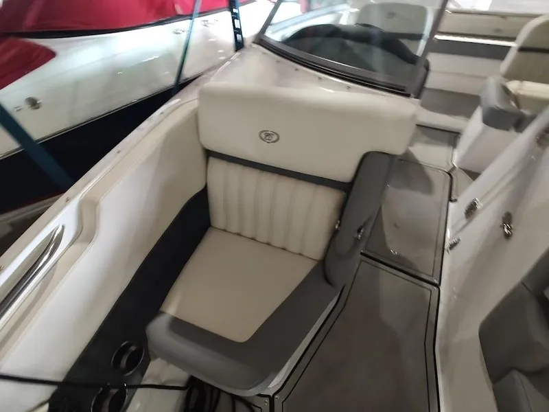 Slide: The Image of 2022 Cobalt 23SC boat interior with white and gray seating. - 21
