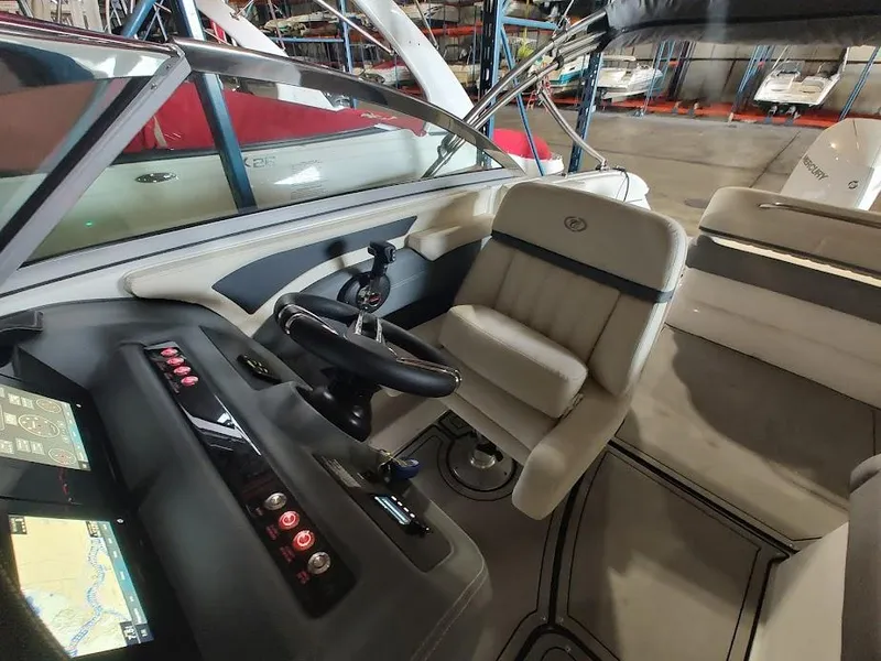 Slide: The Image of 2022 Cobalt 23SC boat interior with captain's seat and control panel. - 24