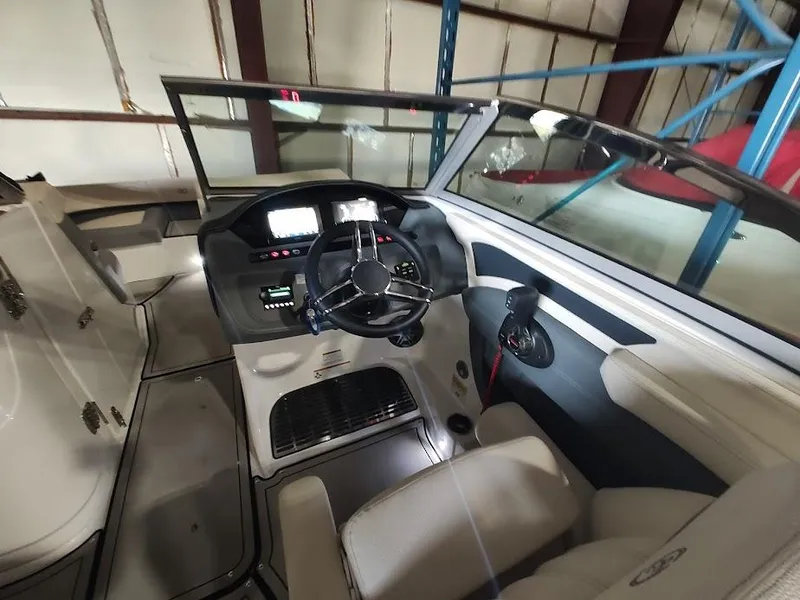 Slide: The Image of 2022 Cobalt 23SC boat interior with steering wheel and control panel. - 28