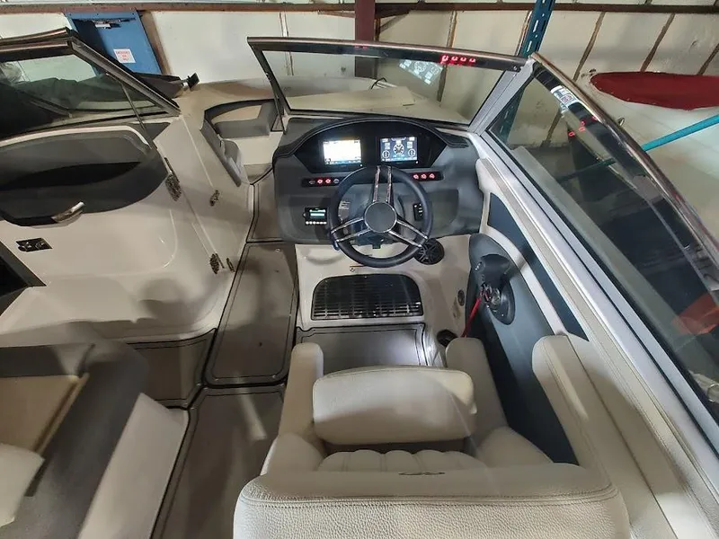 Slide: The Image of 2022 Cobalt 23SC boat interior with steering wheel and dashboard. - 29