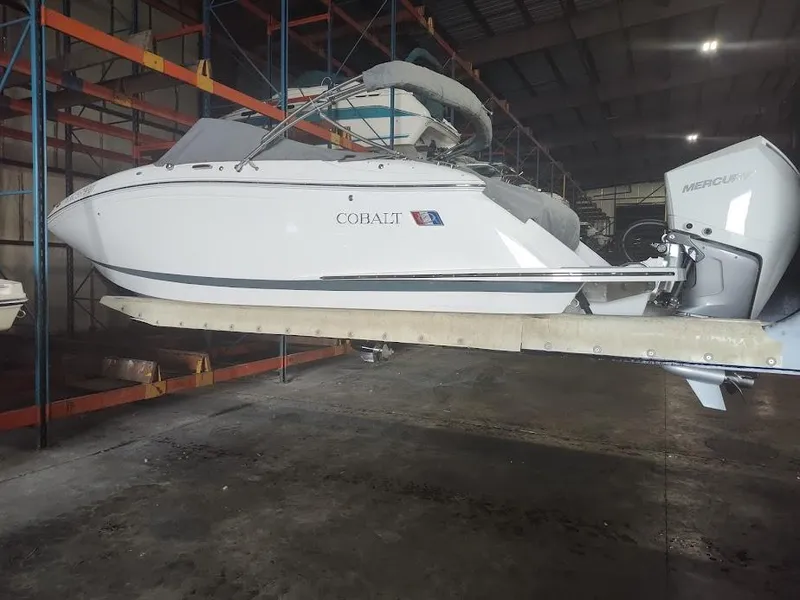Slide: The Image of 2022 Cobalt 23SC boat in storage, side view. - 3