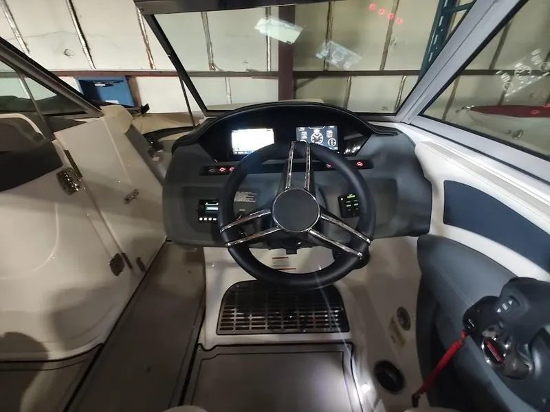 Slide: The Image of 2022 Cobalt 23SC boat cockpit with steering wheel and control panel. - 30