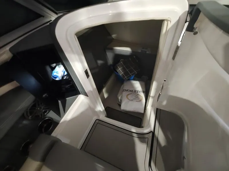 Slide: The Image of Interior cabin of a 2022 Cobalt 23SC boat with seating and storage. - 32