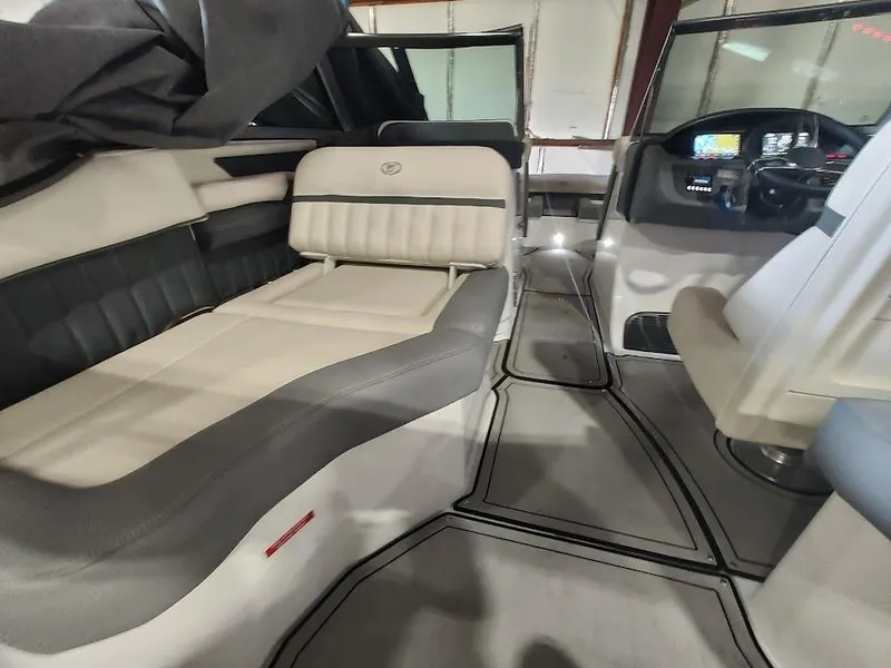 Slide: The Image of Interior of a 2022 Cobalt 23SC boat with luxurious seating and modern dashboard. - 35