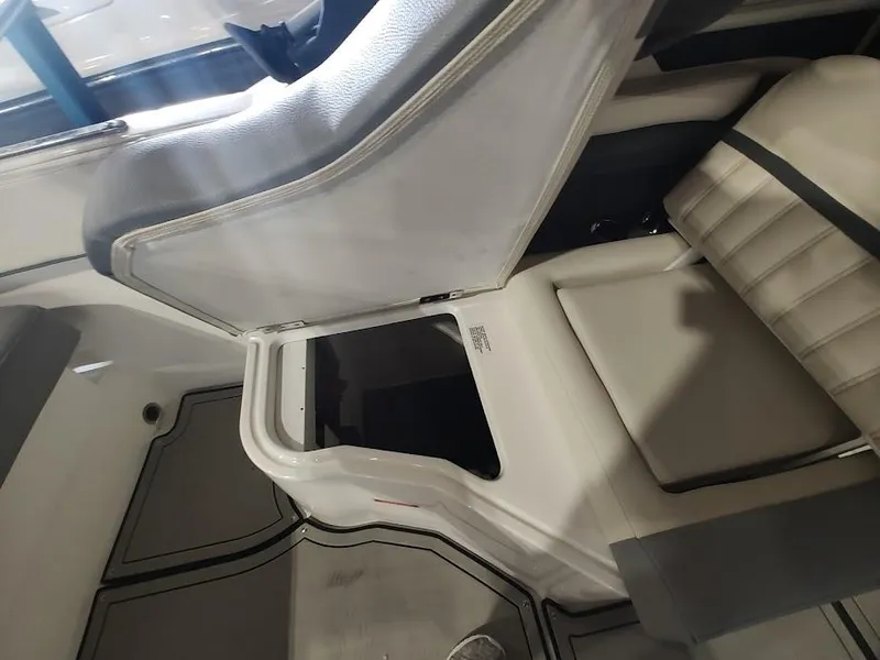 Slide: The Image of 2022 Cobalt 23SC boat interior seating and storage compartment. - 36