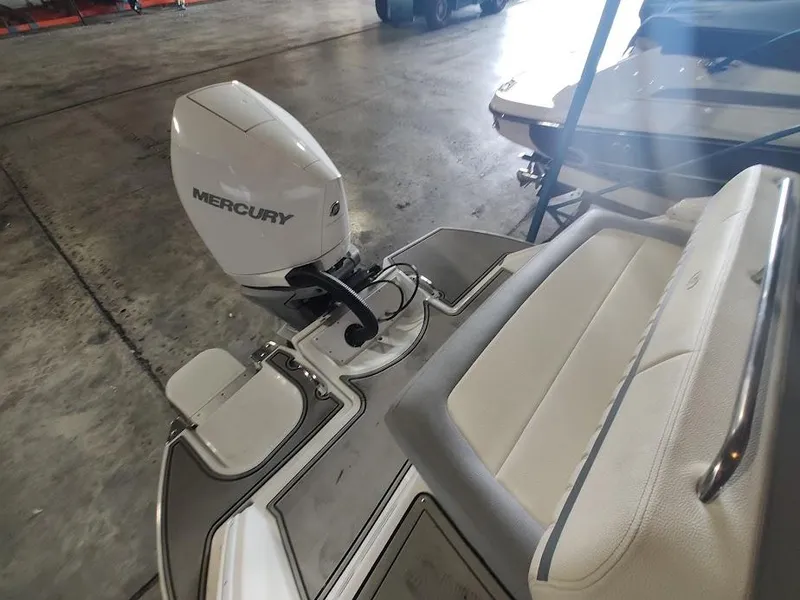 Slide: The Image of 2022 Cobalt 23SC boat with Mercury outboard motor in a storage facility. - 38