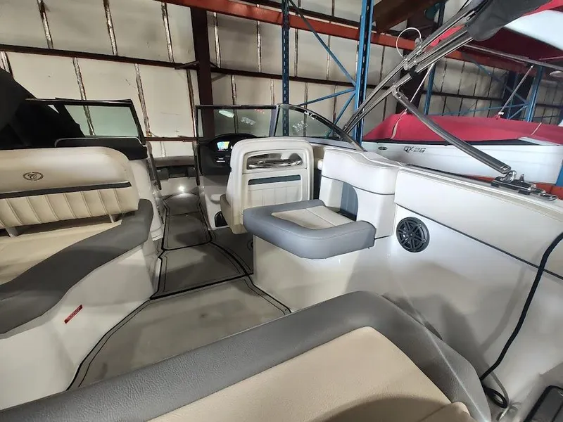 Slide: The Image of Interior of a 2022 Cobalt 23SC boat with seating and steering console. - 40