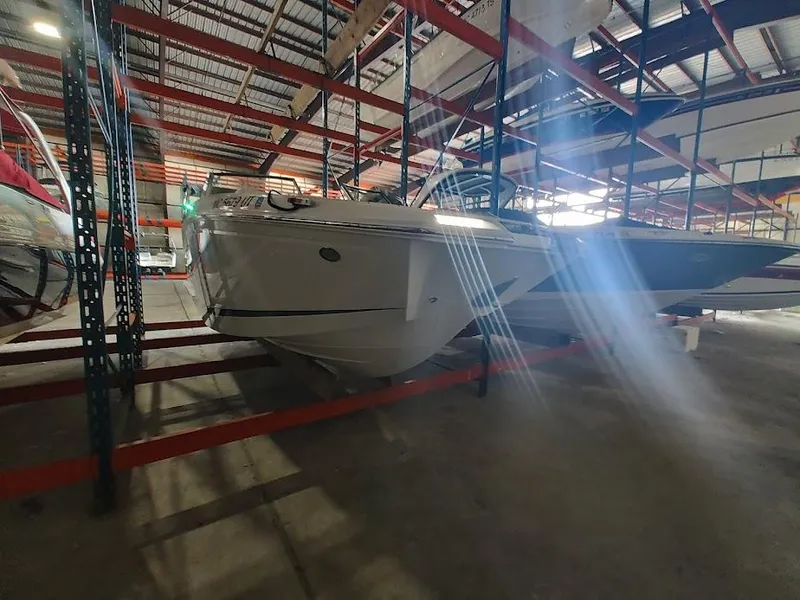 Slide: The Image of 2022 Cobalt 23SC boat stored in a warehouse on a rack. - 43