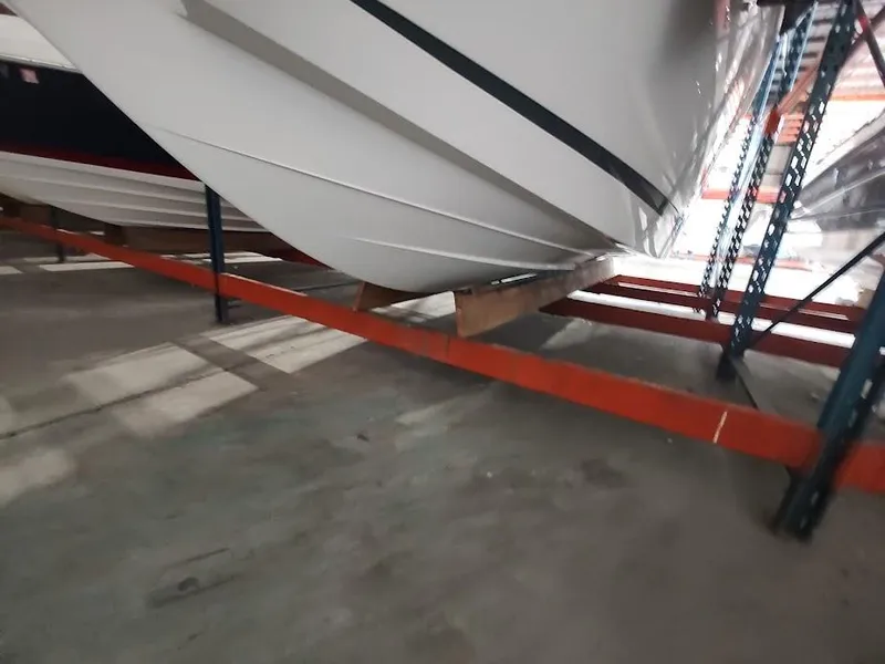 Slide: The Image of 2022 Cobalt 23SC boat stored on a rack in a warehouse. - 47
