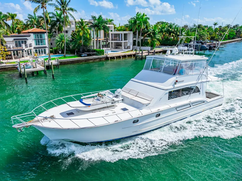 Slide: The Image of 1996 Blackwell 72 yacht cruising in a tropical waterfront area with luxury homes. - 12