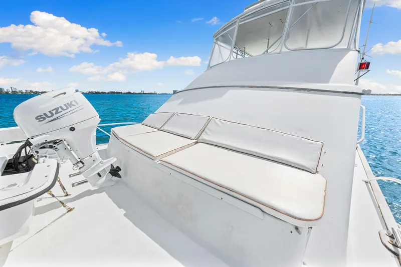 Slide: The Image of White Blackwell 72 boat deck with Suzuki outboard motor, 1996 model, on a sunny day. - 34