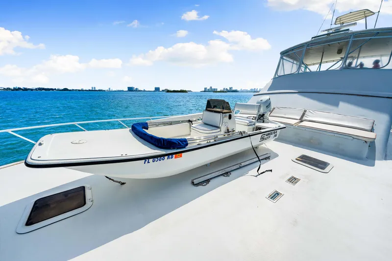 Slide: The Image of Small boat on deck of Blackwell 72 yacht, 1996 model, with ocean and city skyline in background. - 36