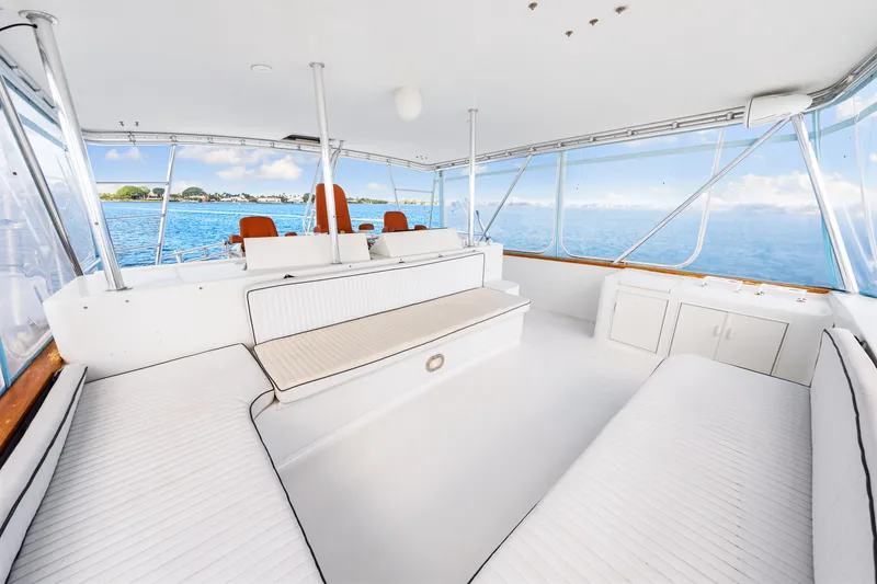 Slide: The Image of Spacious interior of a 1996 Blackwell 72 yacht with white seating and ocean view. - 45