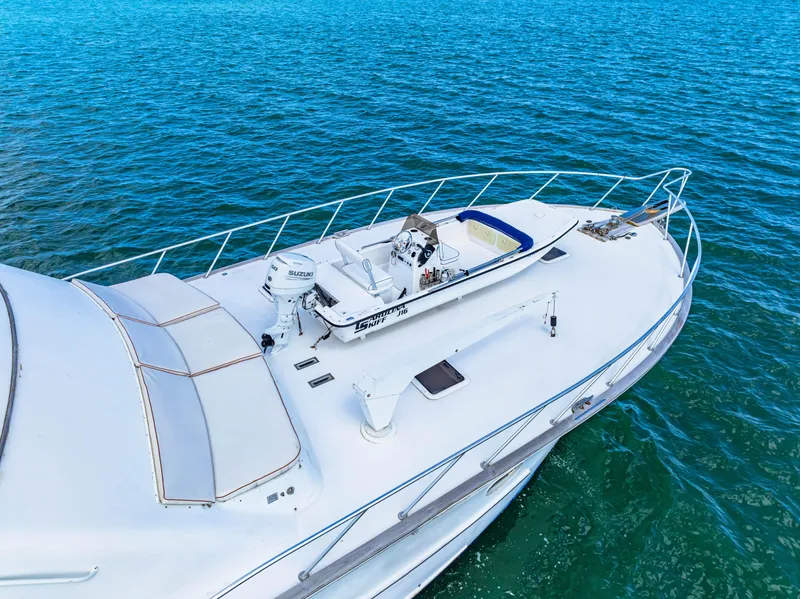 Slide: The Image of Blackwell 72 yacht (1996) with a small boat on deck, sailing in clear blue waters. - 9