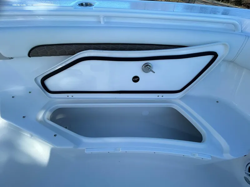 Slide: The Image of 2025 Tidewater 256 LXF boat storage compartment with sleek design and secure latch. - 20