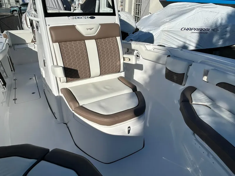 Slide: The Image of 2025 Tidewater 256 LXF boat interior with cushioned seating and sleek design. - 23