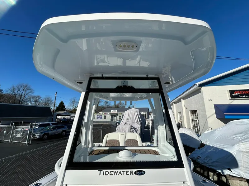Slide: The Image of 2025 Tidewater 256 LXF boat with hardtop and windshield, parked outdoors. - 26