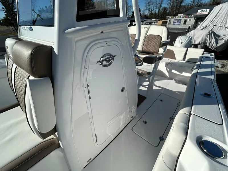 Slide: The Image of 2025 Tidewater 256 LXF boat interior with seating and storage compartments. - 28