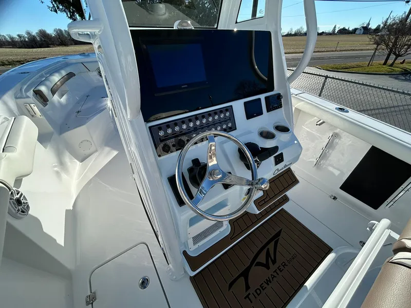 Slide: The Image of 2025 Tidewater 256 LXF boat console with steering wheel and control panel. - 35