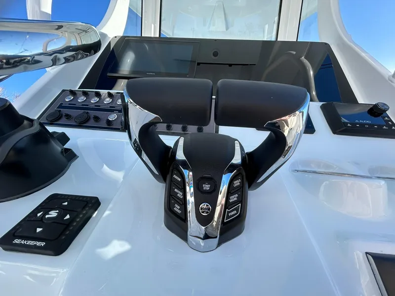 Slide: The Image of 2025 Tidewater 256 LXF boat helm with modern controls and steering wheel. - 38