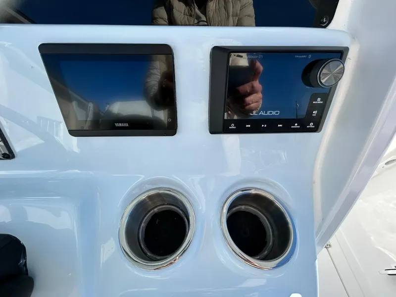 Slide: The Image of 2025 Tidewater 256 LXF dashboard with dual screens and cup holders. - 39