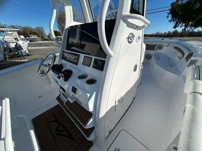 Slide: The Image of 2025 Tidewater 256 LXF boat interior with modern dashboard and steering wheel. - 41