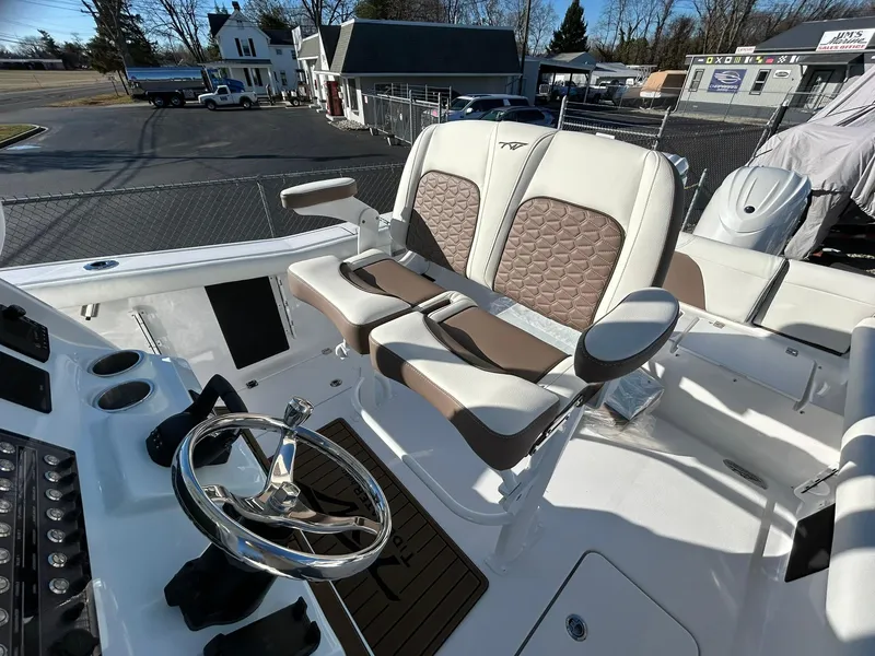 Slide: The Image of 2025 Tidewater 256 LXF boat interior with dual seating and steering wheel. - 45