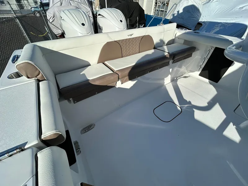 Slide: The Image of 2025 Tidewater 256 LXF boat interior with cushioned seating and modern design. - 49