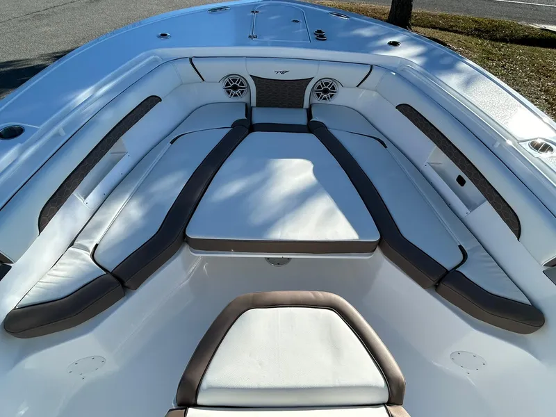 Slide: The Image of 2025 Tidewater 256 LXF boat interior with cushioned seating and speakers. - 7