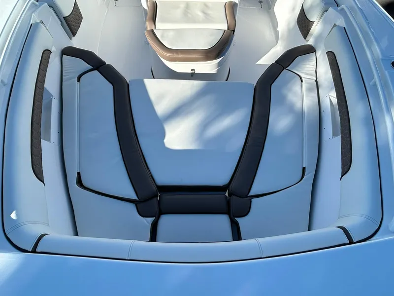 Slide: The Image of 2025 Tidewater 256 LXF boat interior with cushioned seating and sleek design. - 8