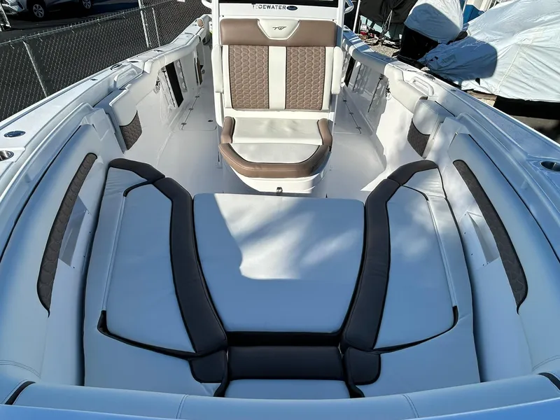 Slide: The Image of 2025 Tidewater 256 LXF boat interior with cushioned seating and modern design. - 9