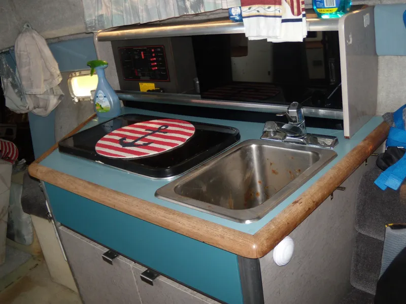 Slide: The Image of Compact kitchen area in a 1988 Bayliner 2655 Ciera Sunbridge boat. - 10