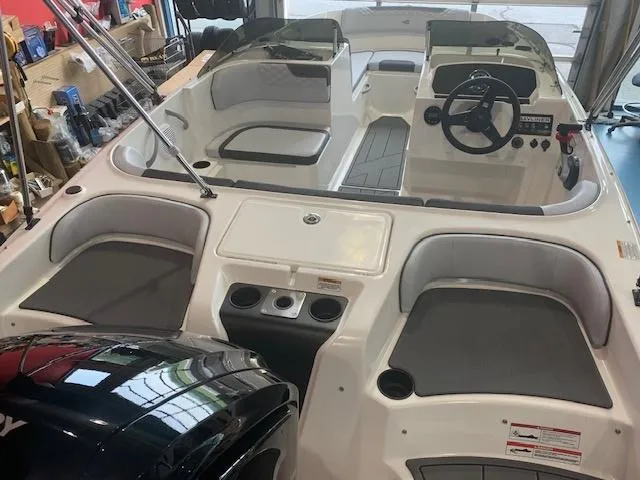 Slide: The Image of 2024 Bayliner Element M17 boat interior with seating and steering console. - 5