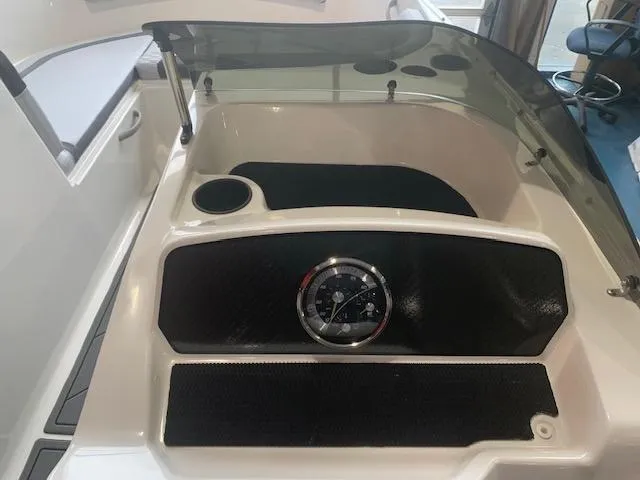 Slide: The Image of 2024 Bayliner Element M17 dashboard with steering wheel and cup holder. - 7