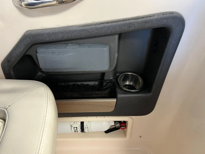 Slide: The Image of 2016 Grady-White Freedom 225 boat interior storage compartment with fire extinguisher and cup holder. - 10