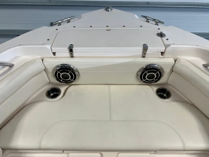 Slide: The Image of 2016 Grady-White Freedom 225 boat interior with cushioned seating and built-in speakers. - 14