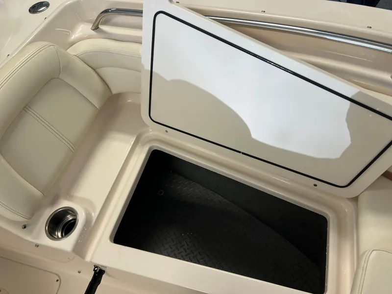 Slide: The Image of 2016 Grady-White Freedom 225 boat storage compartment with open hatch and cushioned seating. - 15